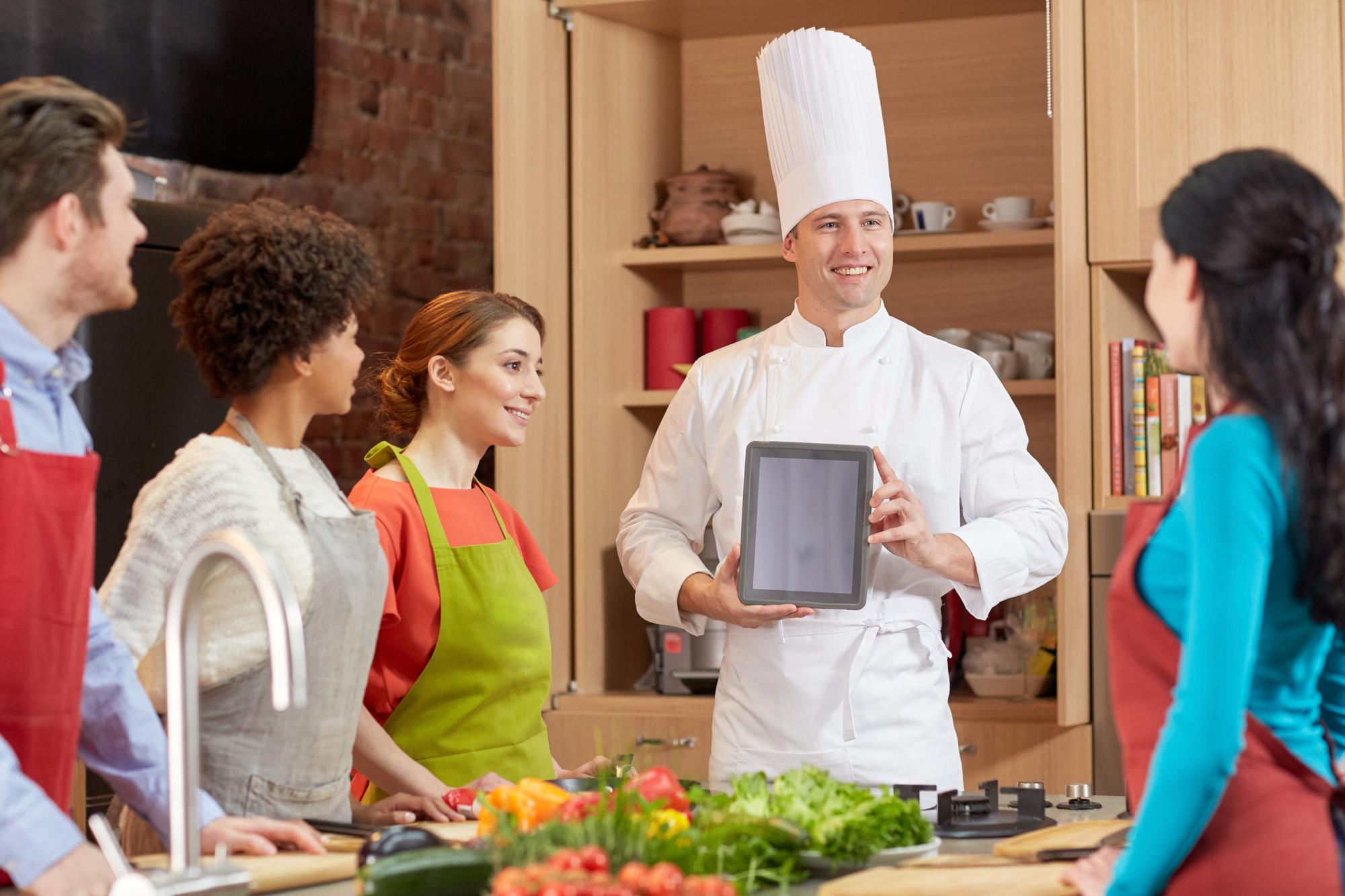 Instructor speaking to participants in demo kitchen